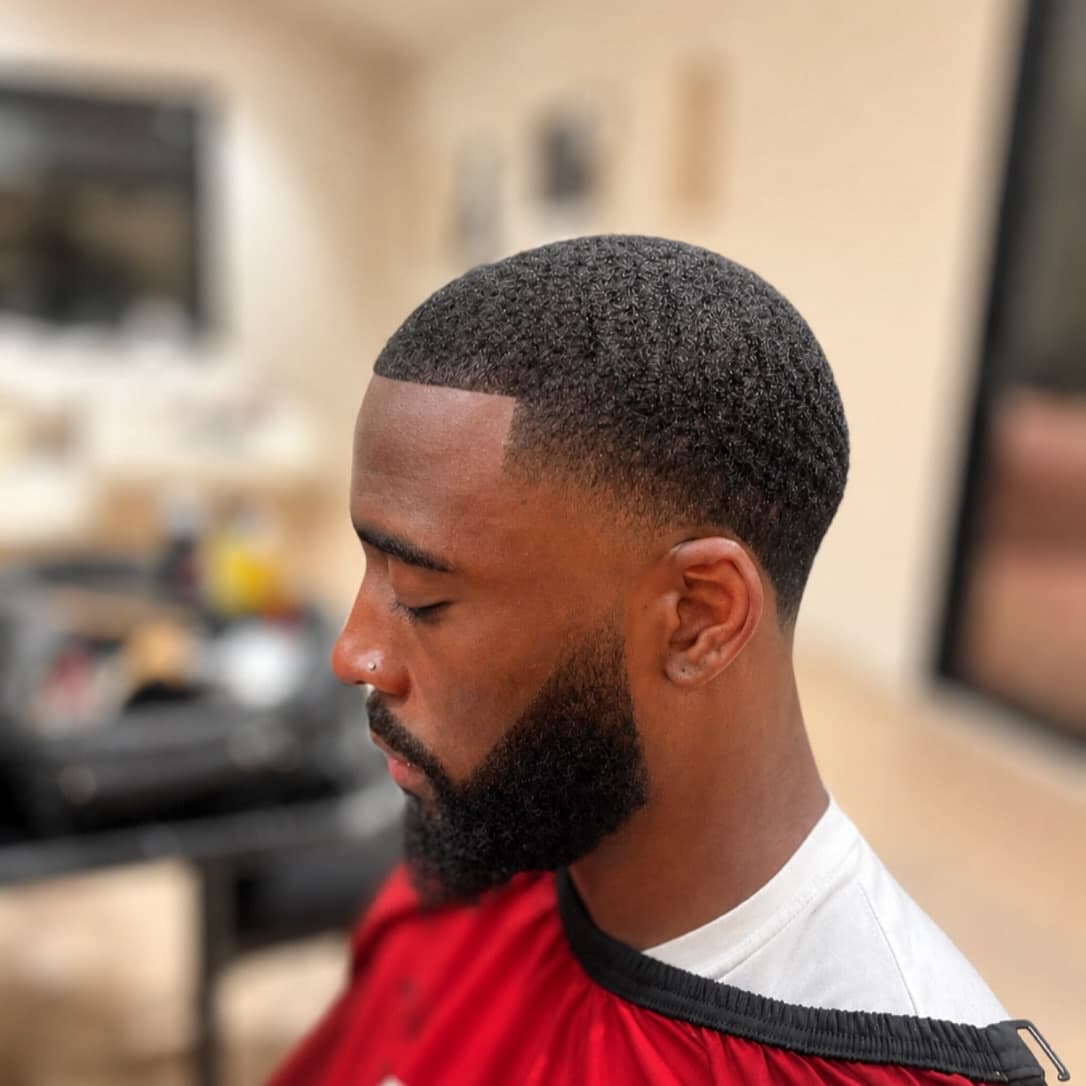 Skin fade and sculpted beard, side profile